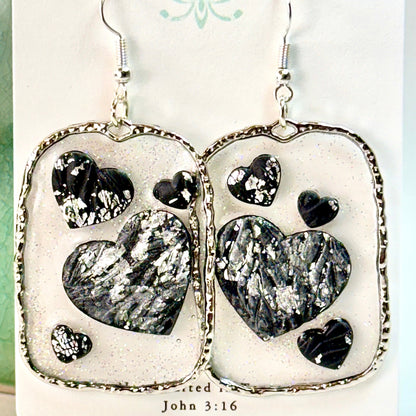 Floating Heart Earrings in Black and Silver Sparkle on white card with text