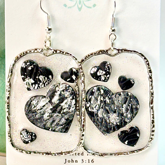 Floating Heart Earrings in Black and Silver Sparkle on white card with text