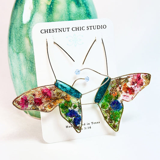 Butterfly hoop earrings with pressed flowers and Austrian crystals. Made by Chestnut Chic Studio.