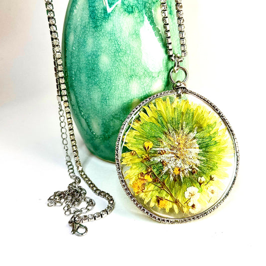 This one-of-a-kind artisan necklace features a green Dahlia with white and yellow mini flowers set in a clear sparkling crystal bezel. Chestnut Chic Studio.