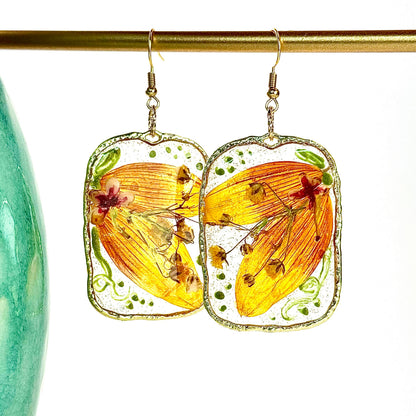 pressed locally sourced sunflower petal earrings set in a gold rectangular hoop