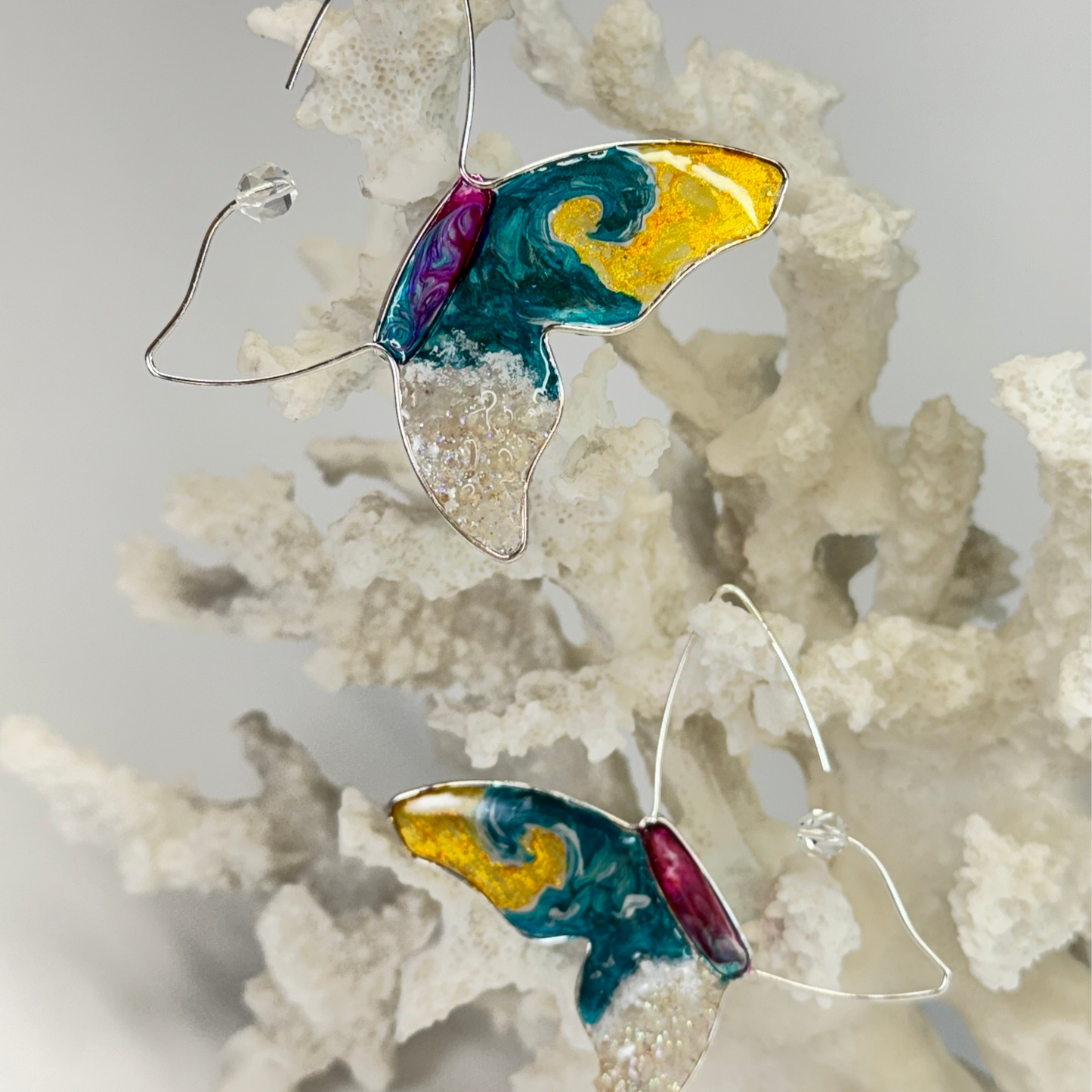 hand painted butterfly earrings with surf waves, real sand, and beachy vibes by chestnut chic studio