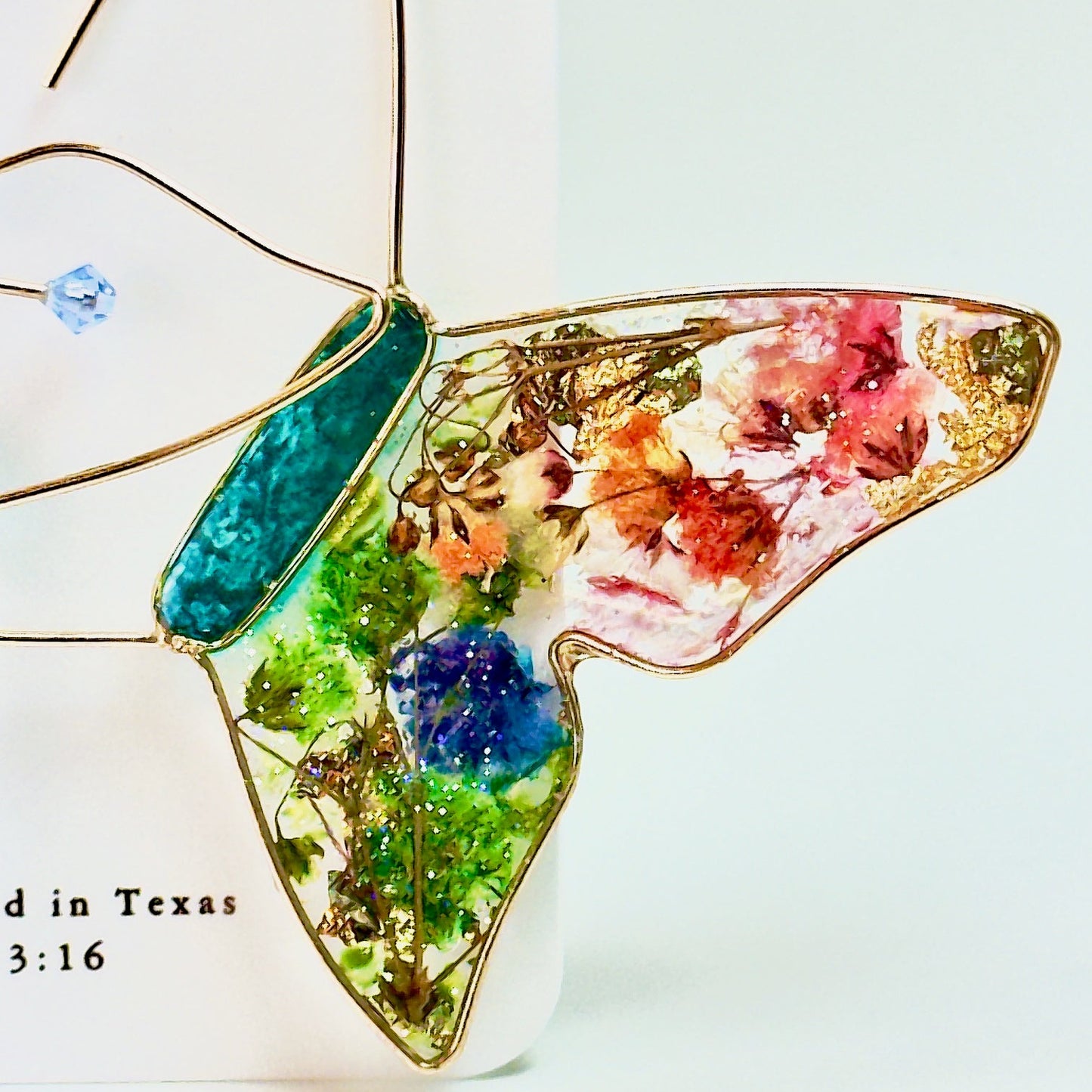 Butterfly hoop earrings with pressed flowers and Austrian crystals. Made by Chestnut Chic Studio.