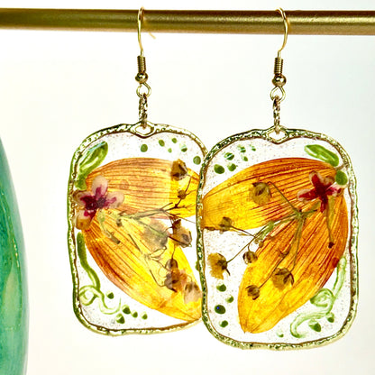 pressed locally sourced sunflower petal earrings set in a gold rectangular hoop